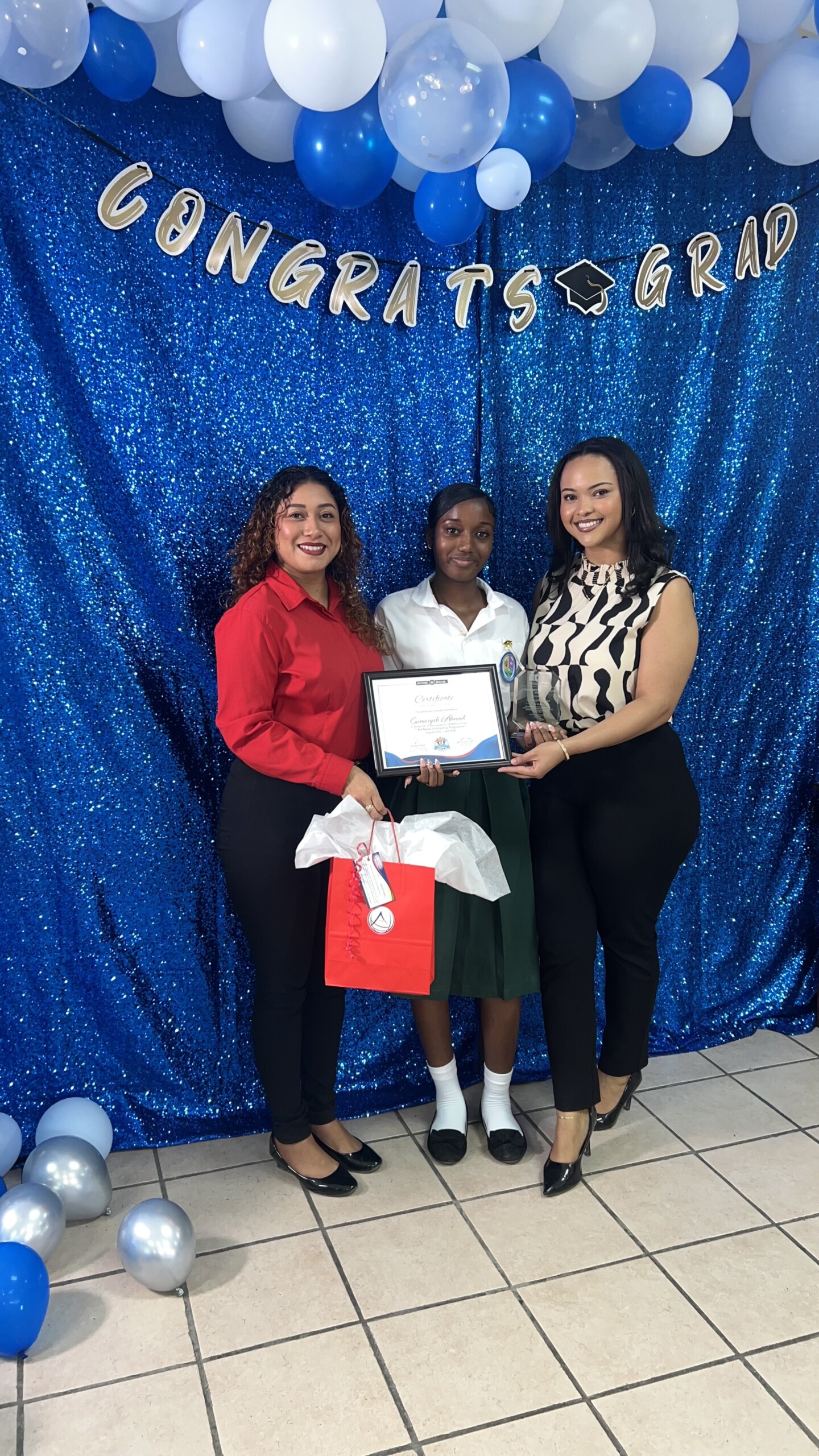 Restore Belize graduation presentation with Atlantic Insurance representatives